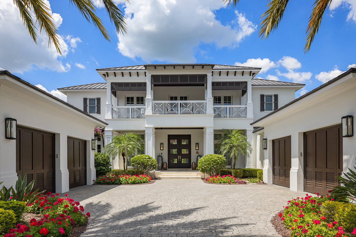 front of home with two two car garages and french doors